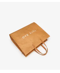 Detailed view of the brown kraft paper tote bag showcasing durable material and sturdy handles.
