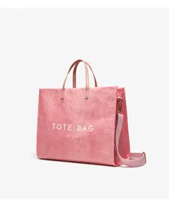 Detail view of the pink kraft paper tote bag with shoulder strap, large capacity and sturdy handles.