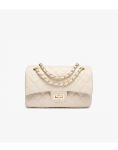 Quilted shoulder bag detail featuring classic diamond pattern and gold chain strap close up.