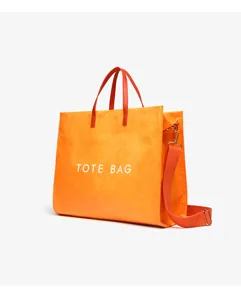 Detailed close-up view of the orange kraft paper tote bag showcasing red handles and strap.
