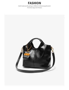 Black leather bucket bag detail, stylish shoulder crossbody bag with chic mini coin purse charm.