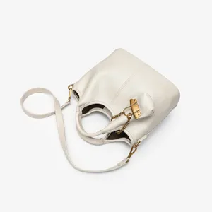 Detail view of the minimalist genuine leather bucket bag featuring chic chain accent and strap.