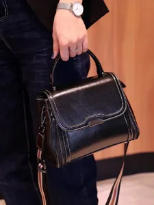 Classic black leather top-handle handbag, stylish retro commuter shoulder crossbody bag.