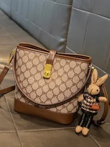 Chic printed bucket bag for women, stylish leather patchwork shoulder crossbody bag.