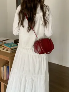 Red bowling bag for women, stylish shoulder crossbody bag with top handle and zipper closure.