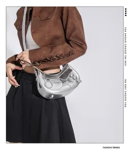 Stylish silver punk motorcycle shoulder bag for women, trendy crescent design with metallic details.