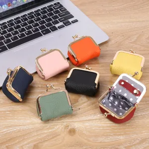 Mini leather kiss-lock coin purse and portable jewelry storage box for rings and earrings.