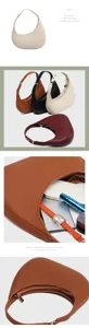Close-up detail of the crescent underarm bag showing smooth zipper and fine leather texture.