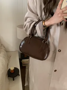 Brown patent leather bowling bag top handle small handbag for women, elegant daily carry.