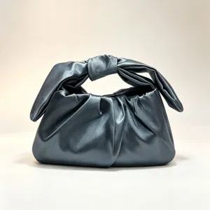 Detailed view of the dark grey metallic gathered leather handbag with chic knotted handle.