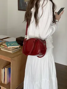Red patent leather bowling bag stylish crossbody shoulder handbag for women everyday use.