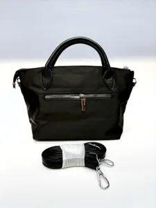 Black nylon handbag with leather handles and removable strap, chic and practical for daily use.
