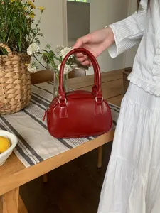 Red bowling handbag for women, chic PU leather underarm bag with top handle for daily wear.