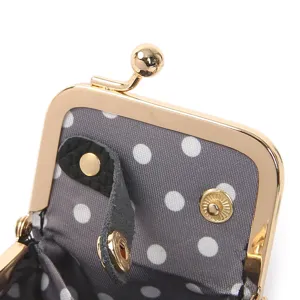 Mini clasp jewelry storage box detail view, polka dot interior lining, portable coin purse.