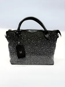 Black rhinestone studded handbag detail, luxury crystal shoulder bag hardware close up.