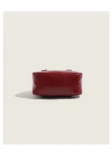 Detail shot of red leather mini bowling bag bottom structure, compact design daily purse.
