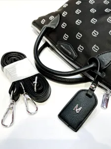 Black rhinestone studded handbag with detachable shoulder strap and monogram leather tag for women.