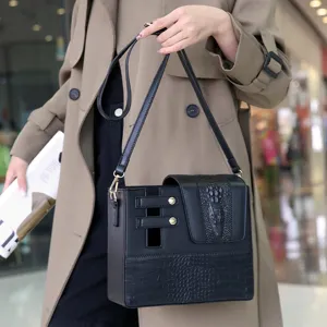Detail view of black leather water cup bag with crocodile pattern and portable crossbody strap.