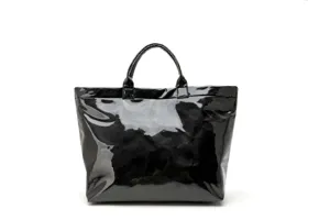 Detailed view of black shiny waterproof tote bag, large capacity stylish handbag for commute.