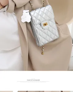 Silver quilted mini phone bag detail, elegant chain strap and luxury metal turn lock closure.