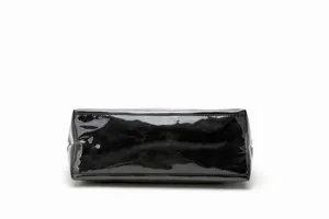 Detailed close-up view of black glossy crinkled waterproof material showing bag texture.