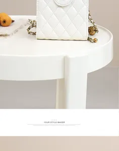 White genuine leather quilted chain phone bag, elegant mini shoulder bag detail view.