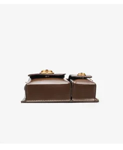 Dark brown leather multi-pocket designer style handbag detail view with gold hardware accents.
