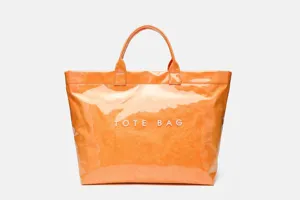Close up of orange waterproof tote bag detail, glossy finish and durable modern design.