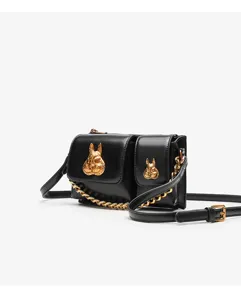 Detailed view of women's black fashion shoulder bag with chic gold rabbit head hardware.