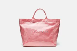 Close-up detail of the pink transparent waterproof tote bag, showcasing large capacity and texture.