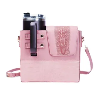 Pink leather crossbody water cup bag with stylish crocodile pattern and tumbler holder slot.