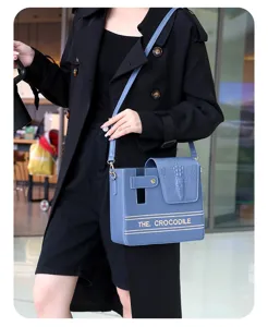 Stylish blue crossbody water bottle bag with crocodile pattern, ideal for outdoor and daily use.