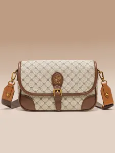 Classic vintage monogram crossbody bag for women, stylish brown leather shoulder bag with retro design.