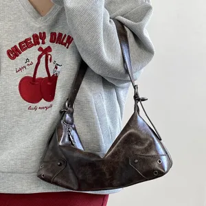 Vintage brown leather underarm shoulder bag for women, retro chic hobo style with chic rivets.