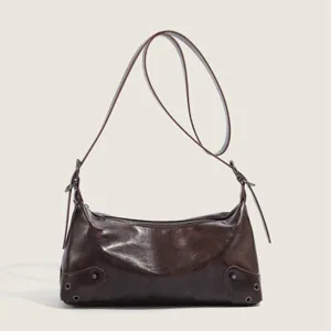 Vintage brown leather underarm bag detail, stylish retro shoulder bag for modern women.