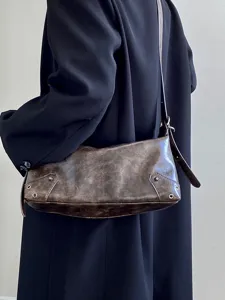 Vintage distressed brown underarm shoulder bag detail, stylish women daily casual handbag.