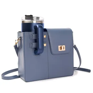 Blue leather water bottle bag with crossbody strap and matching insulated tumbler cup for outdoor.