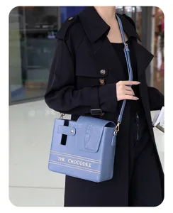 Blue crocodile pattern thermos cup shoulder bag with English text design for outdoor women daily use.