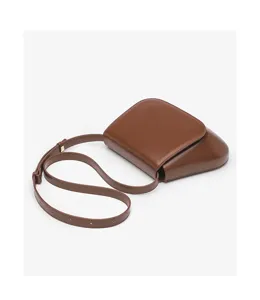 Brown leather saddle bag detail, vintage chic crossbody design, ideal for daily retro style.