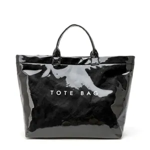 Black glossy tote bag large capacity waterproof handbag for women work commute shopping.