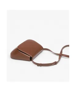 Brown leather saddle bag for women, vintage crossbody purse with slim strap, chic minimalist design.