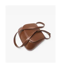 Brown leather saddle bag detail closeup, premium texture, elegant retro style daily handbag.