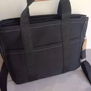 Black canvas diaper bag multi-functional casual shoulder crossbody handbag for mothers daily use.