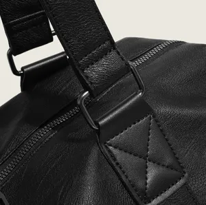 Detailed close-up view of black travel duffel bag strap and durable metal hardware craftsmanship.