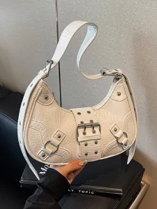 White crescent motorcycle shoulder bag with studs and buckles for women daily commute style.