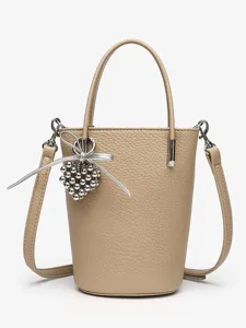 Stylish beige bucket bag with shoulder strap and chic heart charm for women fashion daily use.