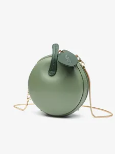Green apple-shaped crossbody bag with gold chain strap, cute round fashion purse for women.