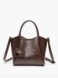 Stylish brown leather bucket bag with top handle and cute elephant charm for women daily