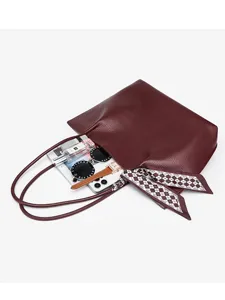 Large capacity burgundy leather tote bag for women, stylish shoulder bag with scarf accessory.