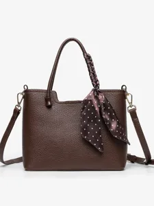 Stylish brown leather tote handbag for women, casual commuting shoulder bag with polka dot scarf.